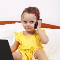 Little girl using modern communication tools