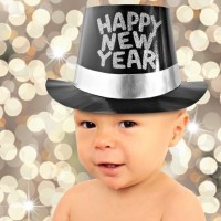 One year old baby boy wearing a Happy New Year top hat.